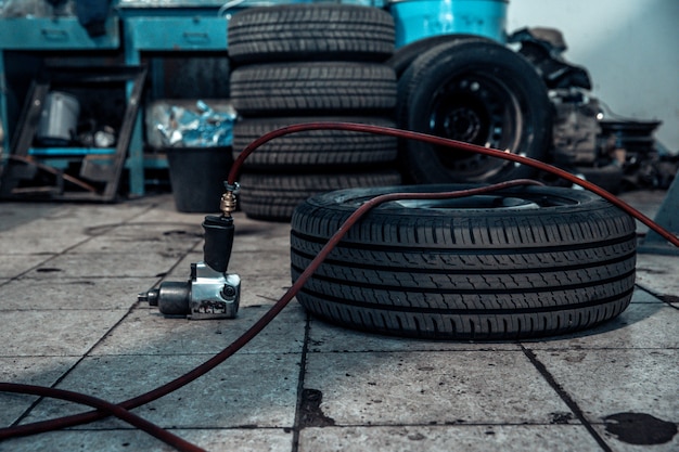 Reparatie en controleer auto in reparatiewerkplaats. Een ervaren technicus repareert het defecte deel van de auto. Ik wissel banden