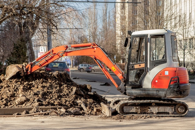 Reparatie van graafmachine voor stadscommunicatie heeft een greppel gegraven voor het vervangen van oude leidingen