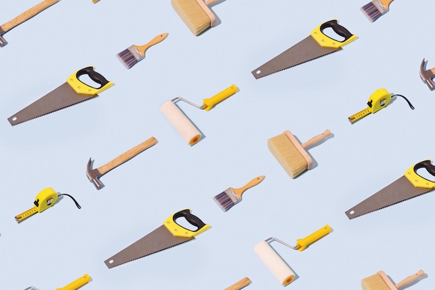Repeat diagonal background pattern of DIY tools with hammer tape saw and paint brushes over a pale blue background in an overhead view