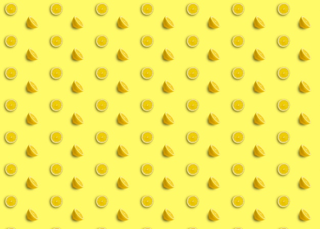 Повторяющиеся узоры из ломтиков и половинок лимона на желтом фоне