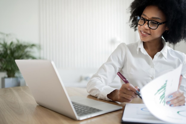 Report manager woman working in office in uses laptop in\
finance company