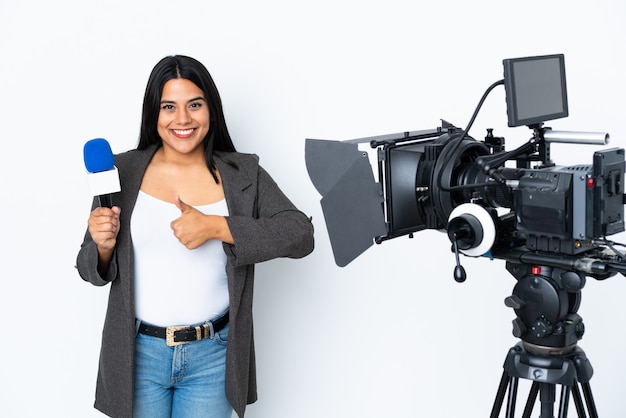 Reporter Colombian woman holding a microphone and reporting news on white