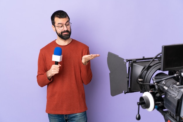 Reporter man over isolated purple background