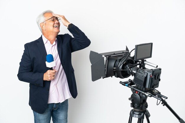 Reporter Middle age Brazilian man holding a microphone and reporting news isolated on white background has realized something and intending the solution