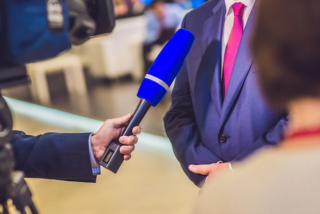 The reporter's hand holds the microphone. Takes an interview