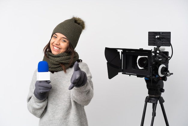 Reporter woman holding a microphone and reporting news isolated