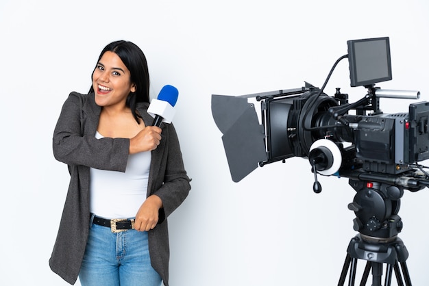 Reporter woman holding a microphone and reporting news on white celebrating a victory