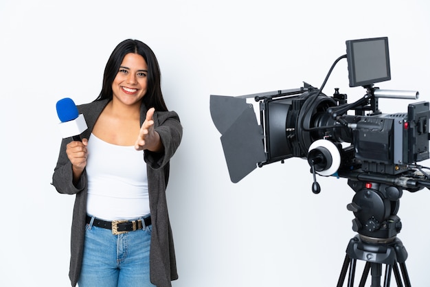 Reporter woman holding a microphone and reporting news on white