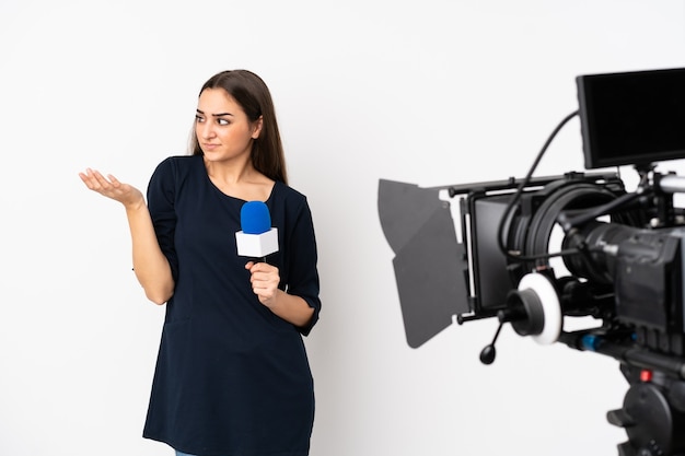 Reporter woman holding a microphone and reporting news