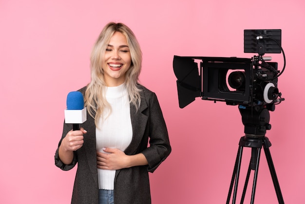 Reporter woman with a camera laughing