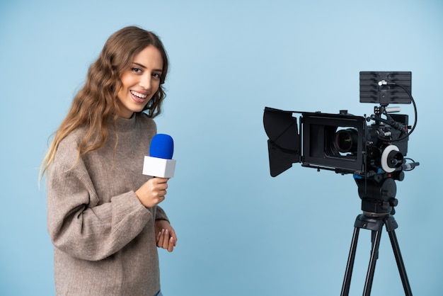 Reporter young woman holding a microphone and reporting news