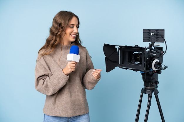 Reporter young woman holding a microphone and reporting news