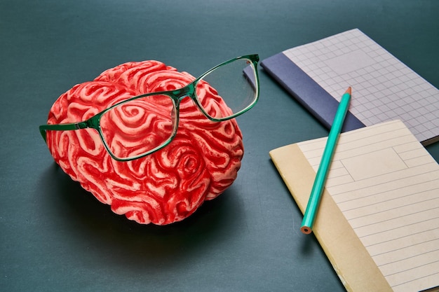 Photo representation of a bandaged red brain with a dark background concept of brain damage