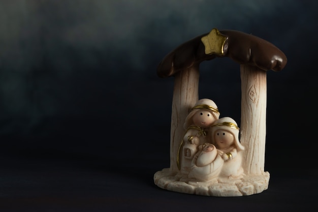 Representation of a Christmas nativity scene with the small figures of baby Jesus, Mary and Joseph on a rock background.