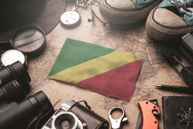 Republic of the Congo Flag Between Traveler's Accessories on Old Vintage Map. Tourist Destination Concept.