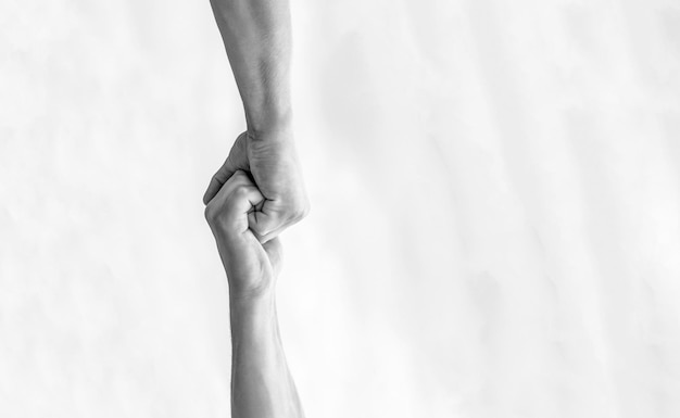 Rescue helping gesture or hands Two hands helping arm of a friend teamwork Helping hand outstretched Friendly handshake friends greeting teamwork friendship