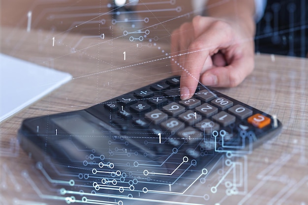 A research and development specialist computing the data to
create a new approach to develop high tech business technological
icons over the desk with calculator woman hand