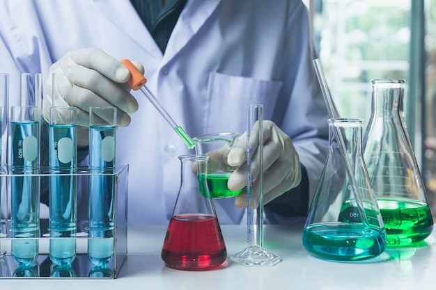 Researcher with glass laboratory chemical test tubes with liquid