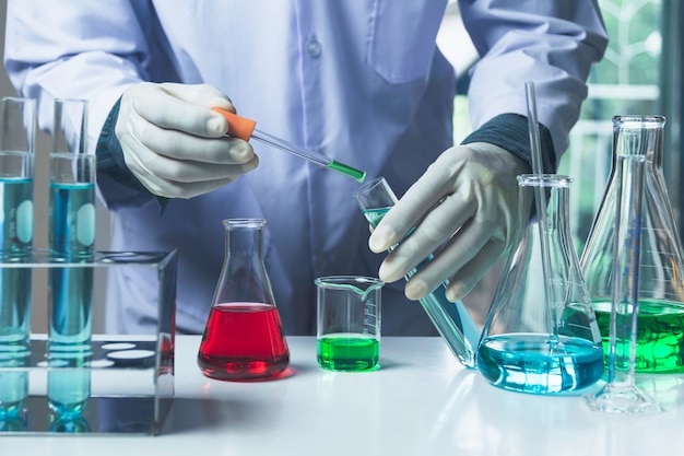 Researcher with glass laboratory chemical test tubes with liquid