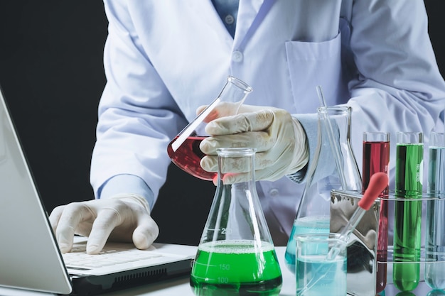 Researcher with glass laboratory chemical test tubes with liquid