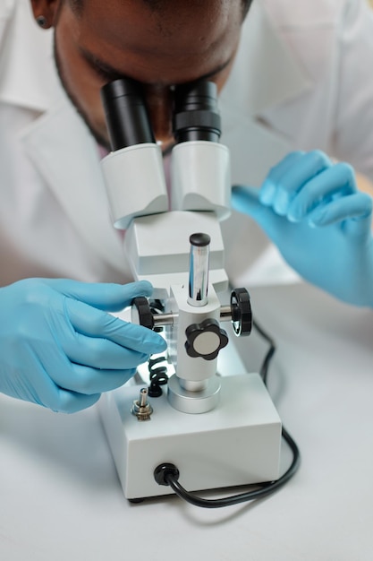 Researcher Working with Microscope