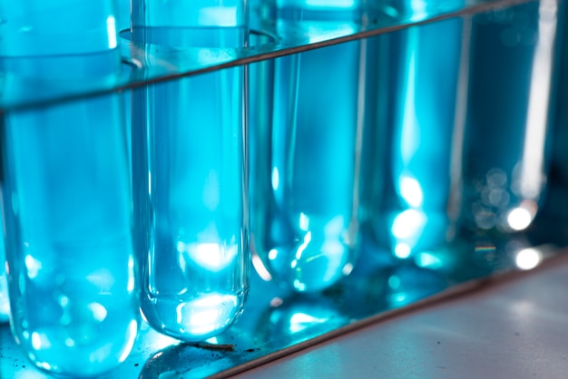 Researchers are using glassware and blue solutions in laboratories, research on cosmetics and energy.