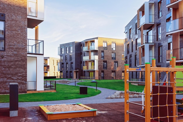 Residential apartment house building exterior concept. Children playground outdoor facilities