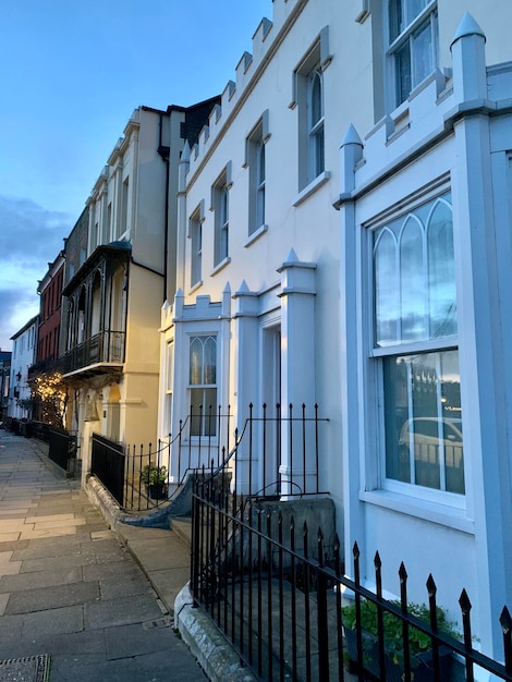 Residential building by street against sky