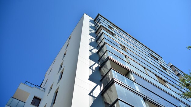 Residential building on sky background facade of a modern housing construction with of balconies