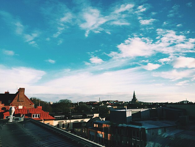 Residential buildings against cloudy sky