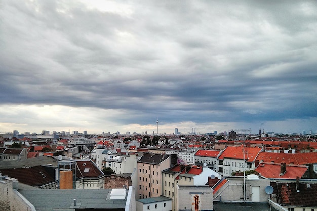 Residential buildings against cloudy sky