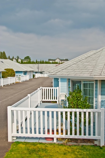 Residential house with chair and decorative tree on patio deck