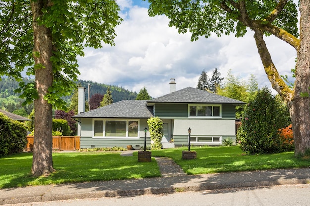 Residential house with concrete pathway over front yard