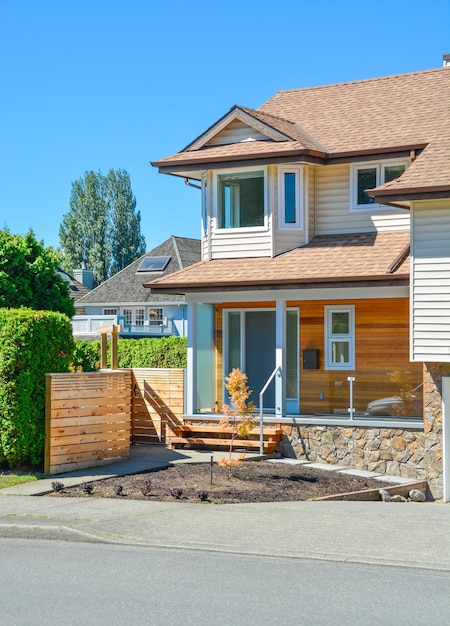 Residential house with porch and concrete pathway over the front yard