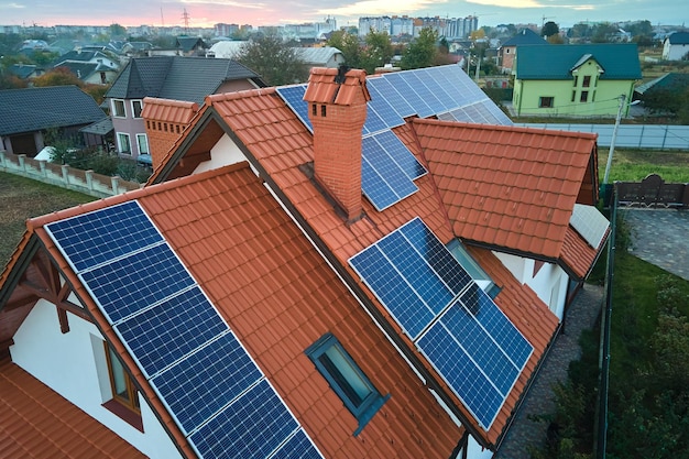 Residential house with rooftop covered with solar photovoltaic panels for producing of clean ecological electrical energy in suburban rural area Concept of autonomous home