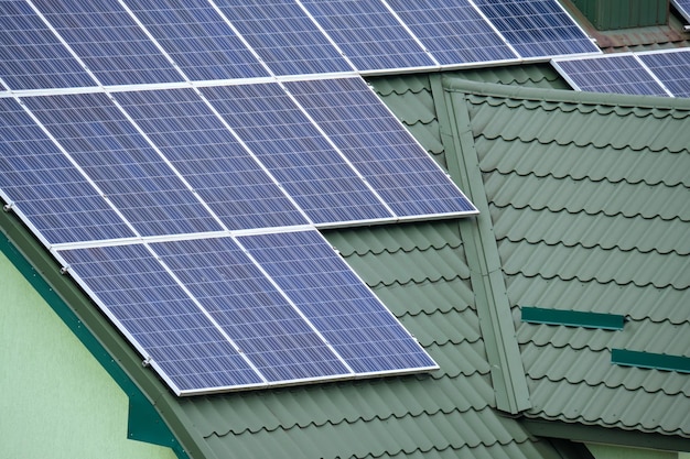 Residential house with rooftop covered with solar photovoltaic\
panels for producing of clean ecological electrical energy in\
suburban rural area concept of autonomous home