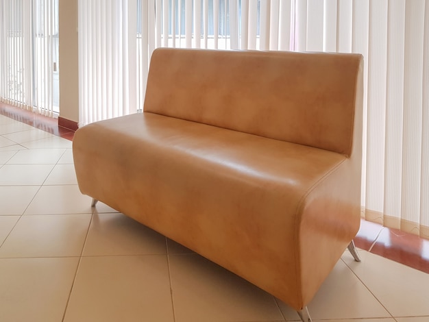 Residential interior of a modern living room with a sofa and a panoramic window with blinds OR OFFICE interior