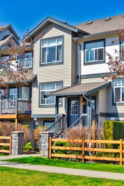 Photo residential townhouse entries with wooden fence in front