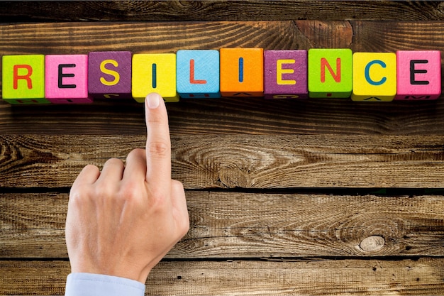 Resilience sign with wooden cubes on background