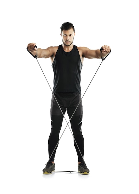 Resistance training really works Studio shot of a young man working out with a resistance band against a white background