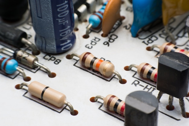 Resistor, Capacitor and Transistor on Circuit Board close up. electronic hardware