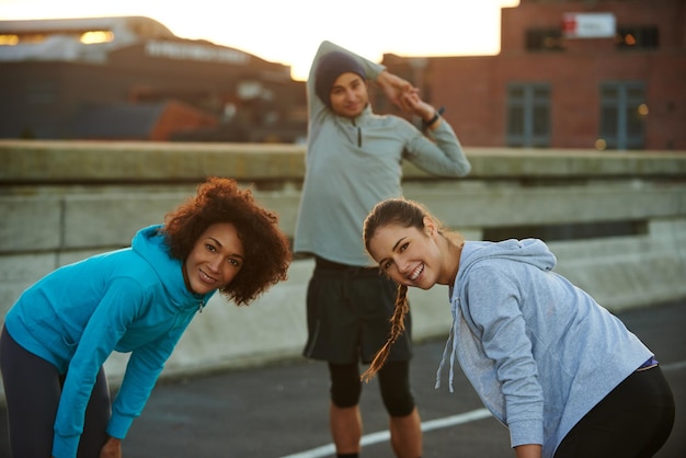 Rest fitness and portrait of friends in city for exercise marathon training and workout in town Sports happy and people for stretching recovery and breathe for performance health and running