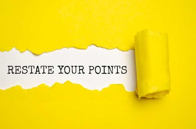 RESTATE YOUR POINTS written under torn paper