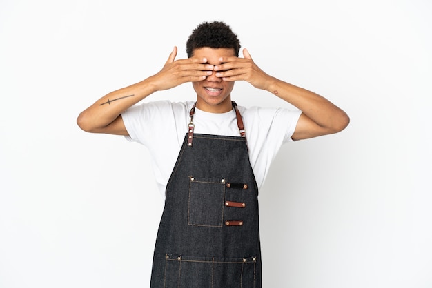 Restaurant African American waiter man isolated on white background covering eyes by hands