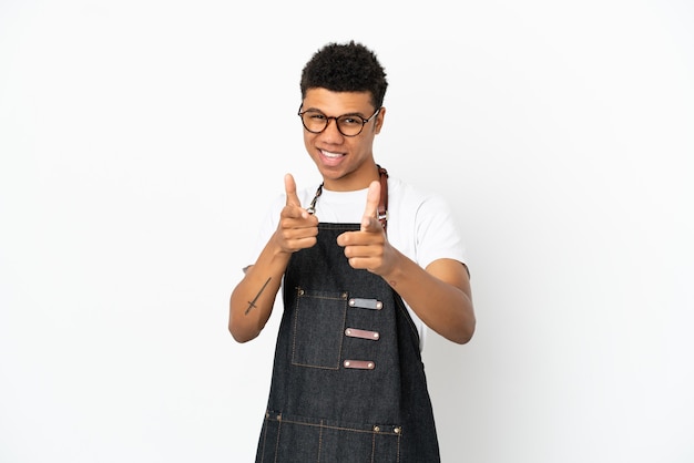 Restaurant African American waiter man isolated on white background pointing to the front and smiling