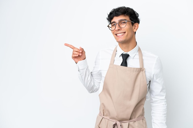 Restaurant Argentinian waiter isolated on white background pointing finger to the side