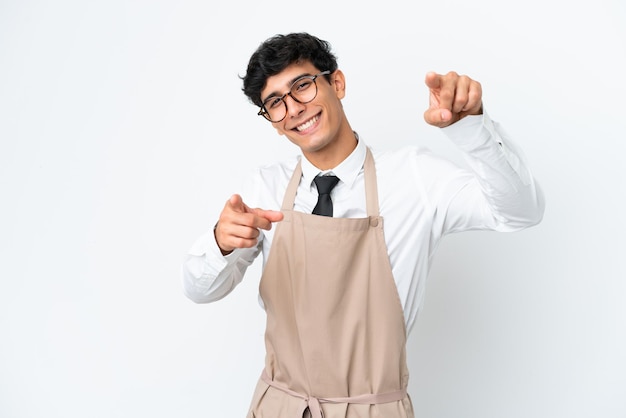 Restaurant Argentinian waiter isolated on white background points finger at you while smiling