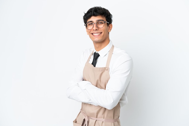 Restaurant Argentinian waiter isolated on white background with arms crossed and looking forward