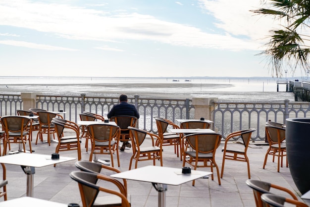 Restaurant bar terrace on the waterfront square and pier of Andernos-les-Bains in gironde France