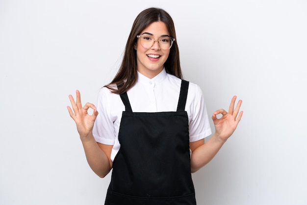 Restaurant Brazilian waiter woman isolated on white background showing an ok sign with fingers